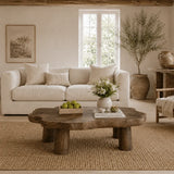 Contemporary coffee table with freeform slab shape and solid wood legs for inviting spaces