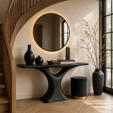 Curved console table displayed beneath sailboat art in a calm luxury coastal interior