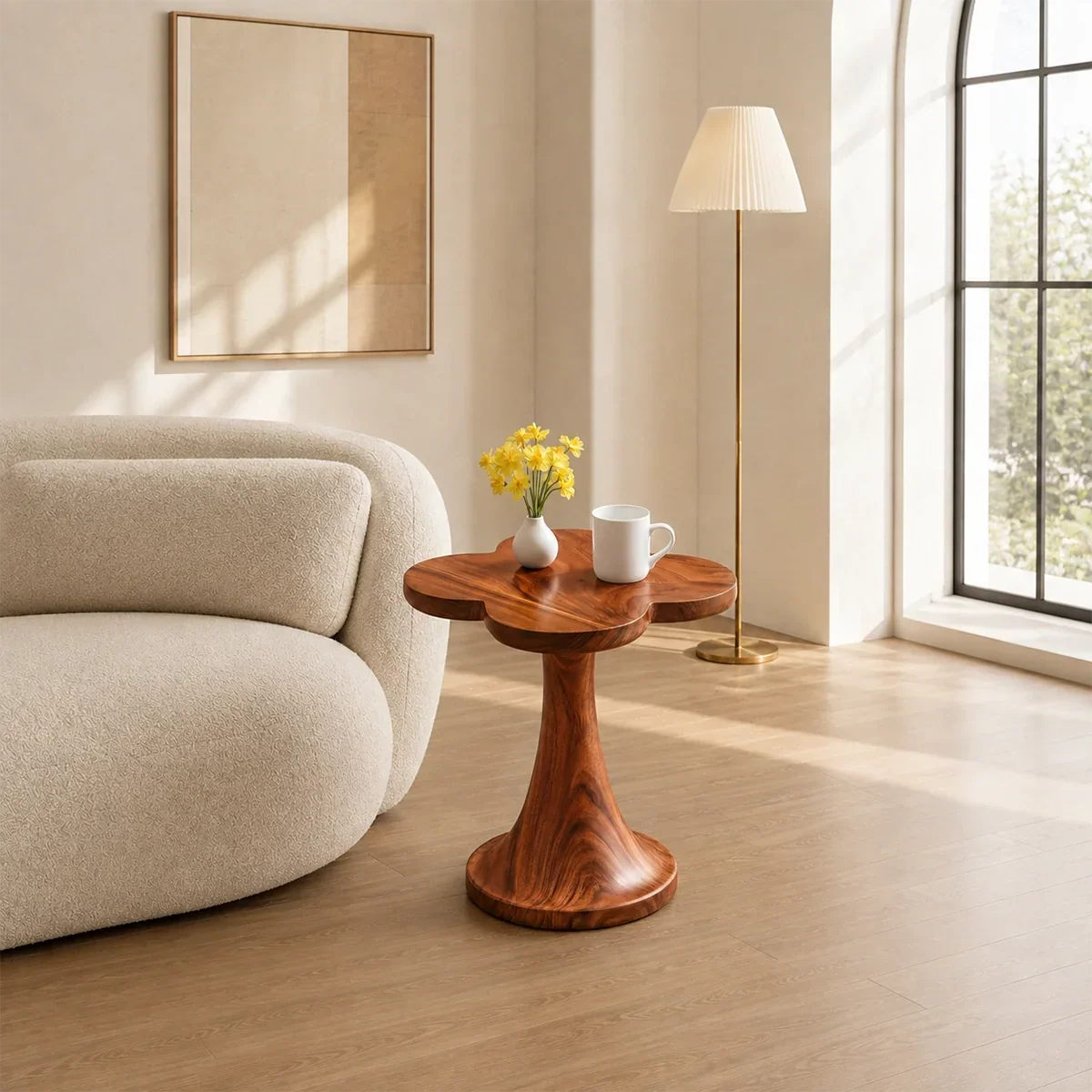 Organic modern side table styled beside curved seating in a calm neutral room indoors