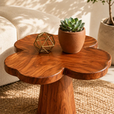 Accent end table featuring a petal shaped top and tapered pedestal base for home decor