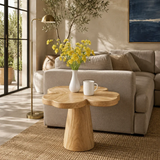 Curved side table adds floral character and practical surface to serene home interiors