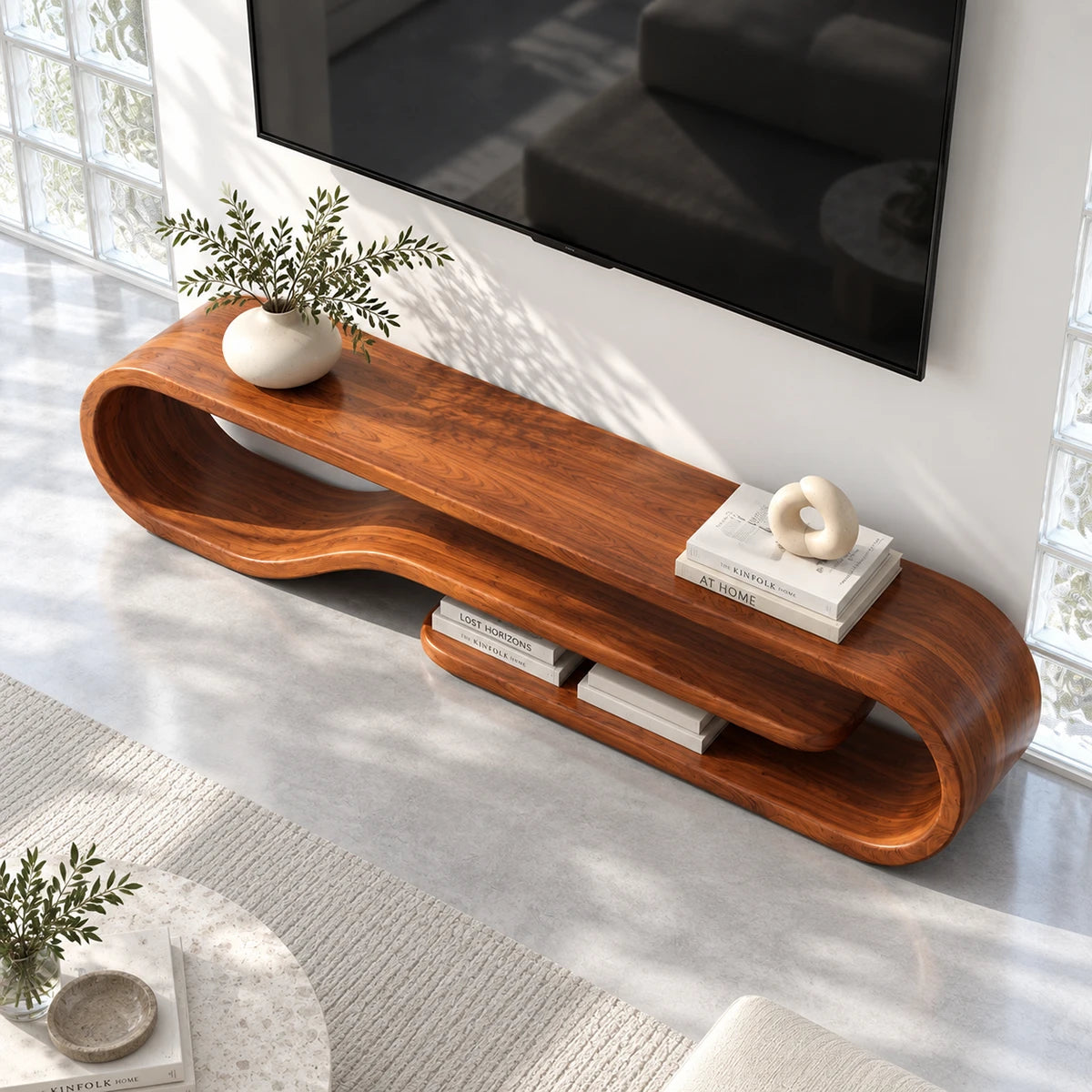 Designer entertainment unit in solid wood with soft curves and a floating shelf detail
