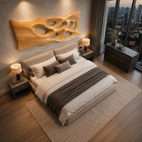 Modern wall sculpture with sweeping contours adds architectural interest above the bed