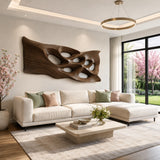 Statement wall art with carved openings introduces depth to a contemporary bedroom wall