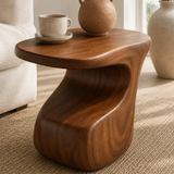 Accent end table featuring a curved pedestal form and compact top for home styling
