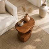 Curved side table adds sculptural character and practical surface to serene interiors