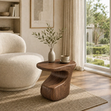 Statement end table with organic lines and rich wood tone in a minimalist room setting