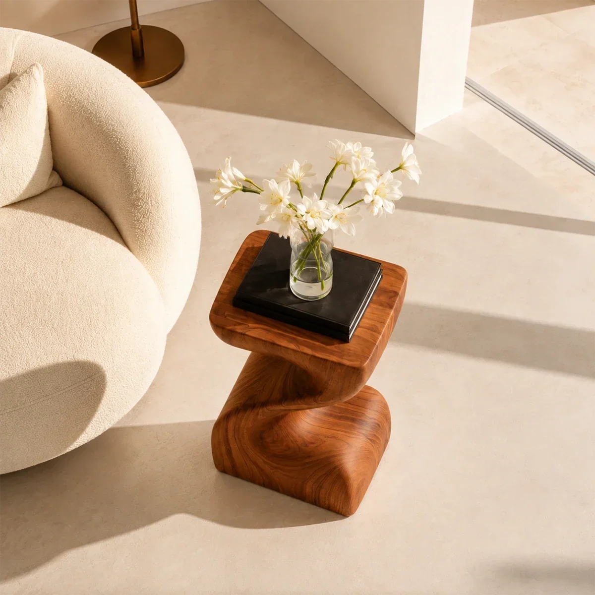 Curved side table adds fluid character and practical surface to serene home interiors