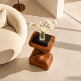 Curved side table adds fluid character and practical surface to serene home interiors