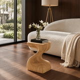 Luxury side table with sculptural base and compact top in a bright elegant interior