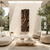 Vertical sculptural wall art with wave-like relief enhances a clean contemporary setting