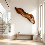 Sculptural wall art with flowing carved contours creates a bold focal point in interiors
