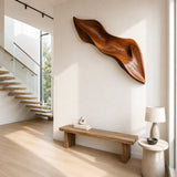 A long abstract wall art piece with sweeping curves brings depth to contemporary interiors