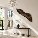 Carved wall art with smooth sweeping lines introduces artistic depth to minimalist rooms