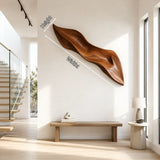 Curved sculptural wall decor adds movement and dimension to a bright contemporary entryway