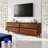 Elegant media stand in solid wood featuring four drawers, slim legs, and brass pulls
