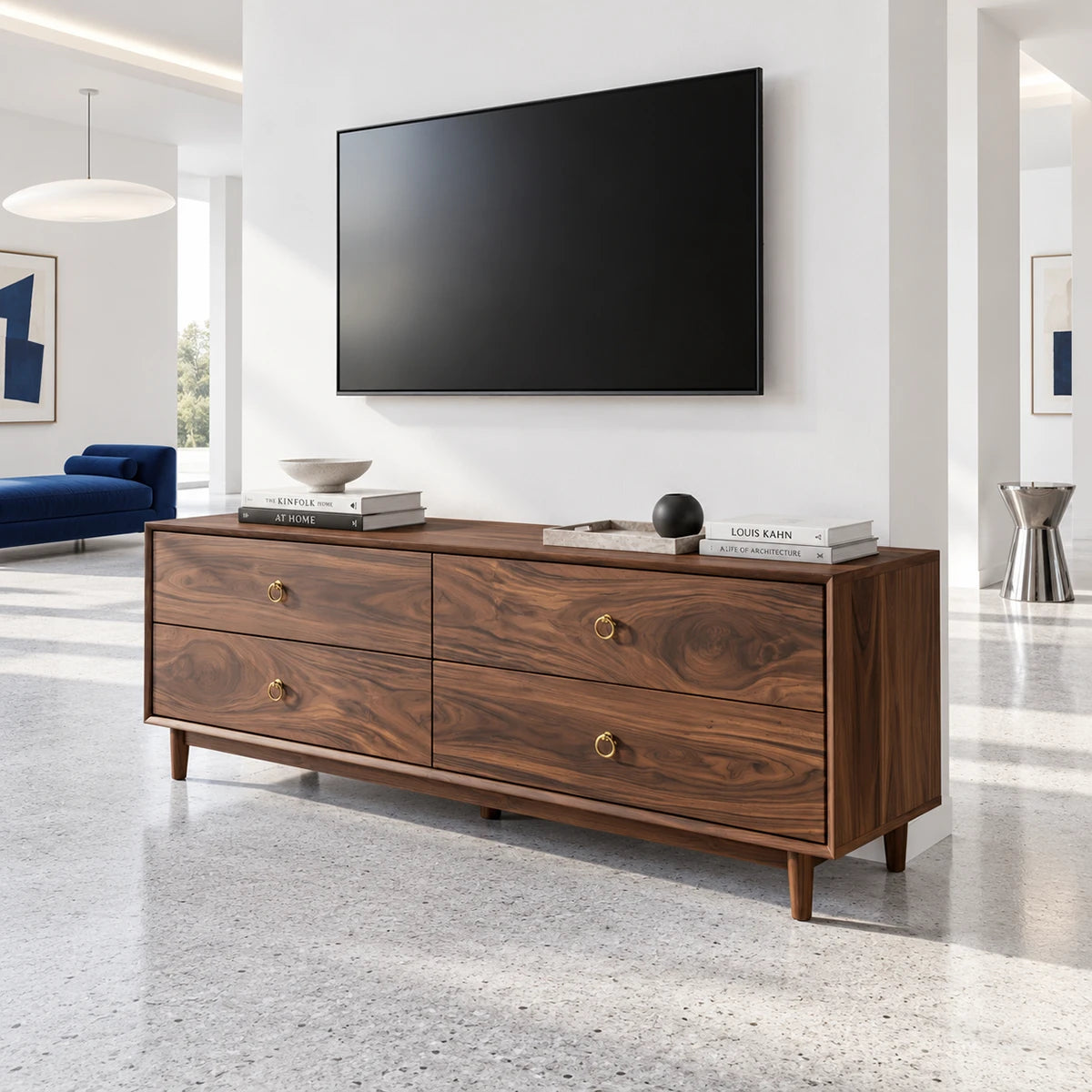 Four drawer TV cabinet in solid wood with tapered feet and brass ring pulls detail
