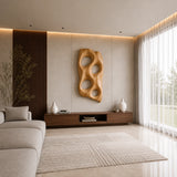 Abstract wall sculpture with four open cutouts adds depth to a modern living room