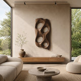 Statement wall sculpture with smooth cutouts introduces depth to a minimalist setting