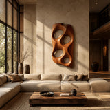 Designed with sculpted openings, this wall art brings movement to a modern interior