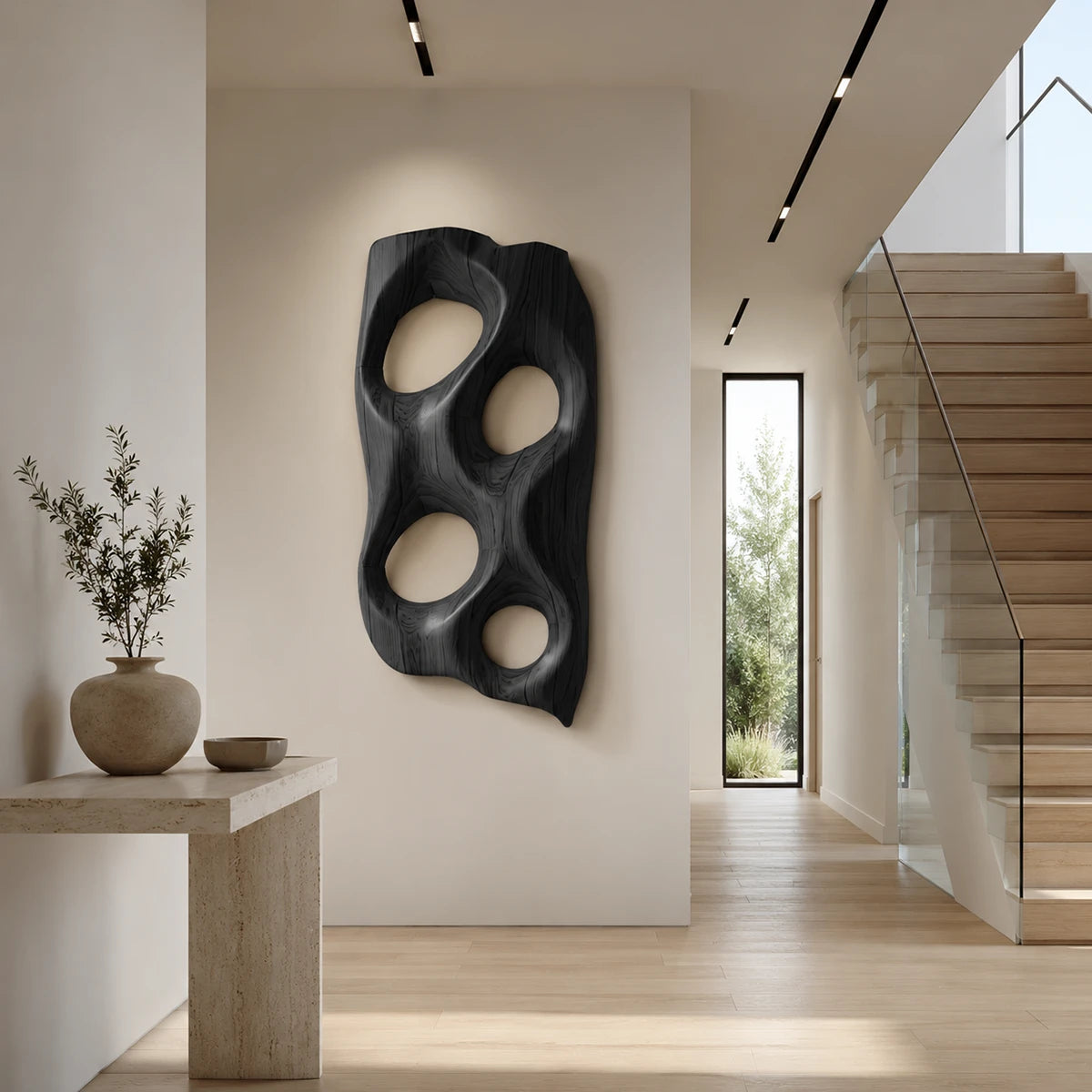 Large decorative wall panel with carved voids creates visual interest in open spaces
