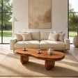 A sculptural coffee table with freeform top styled in a calm modern living room setting