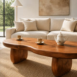 Contemporary coffee table with soft curves and sculpted legs in a serene home space