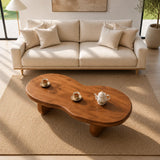Designer coffee table with an organic outline and sturdy base in a sunlit room interior