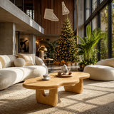 Statement coffee table with flowing silhouette and warm finish in a serene beach room