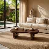 Artisan coffee table with sculpted legs and natural texture in a calm modern interior