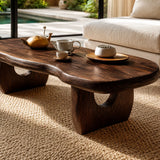 Designer coffee table featuring a freeform top and visible grain in a sunlit home