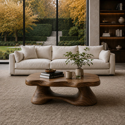 Premium coffee table with rounded contours and low sculpted base for elegant interiors