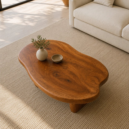Designer coffee table with an irregular top and handcrafted solid wood pedestal-style legs