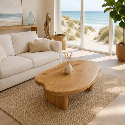 Statement coffee table with freeform top and bold solid wood supports for modern interiors