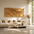 Horizontal wall art with layered carved waves adds depth above a modern living room sofa