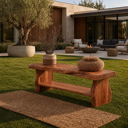 Sculptural bench with lower shelf styled in a modern patio for elegant outdoor seating