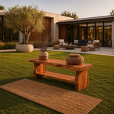 Organic modern bench with sculpted legs and shelf display in a serene garden setting