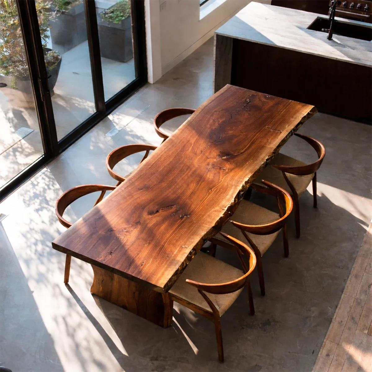 Minimalist dining table with natural wood grain detail, warm and refined contemporary space