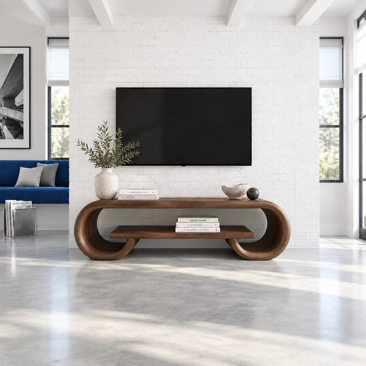 Sculptural TV stand in solid wood with rounded ends and a floating center shelf design
