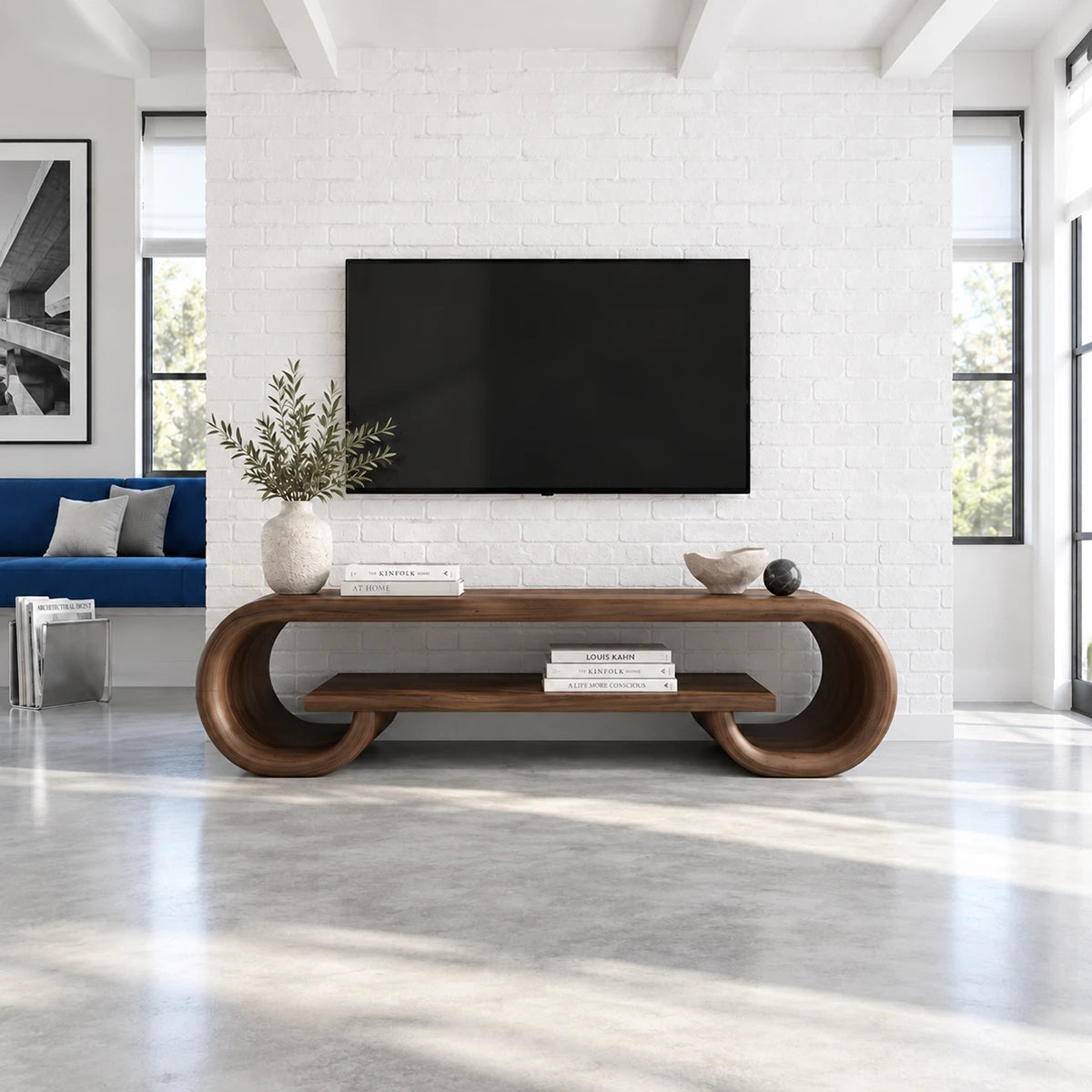 Wide entertainment console in solid wood with smooth curves and open lower storage
