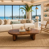Low profile coffee table featuring a wide organic top and substantial solid wood supports
