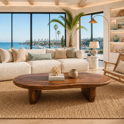 Sculptural coffee table with a broad top and low solid wood legs for modern living spaces
