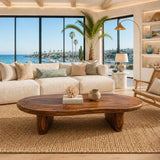 Sculptural coffee table with a broad top and low solid wood legs for modern living spaces
