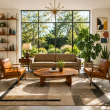 Living room coffee table with a broad curved top and sturdy handcrafted solid wood base