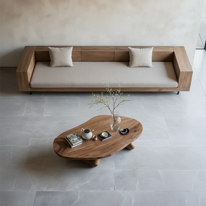 Walnut coffee table with artistic base structure and rounded edges in a clean contemporary setting