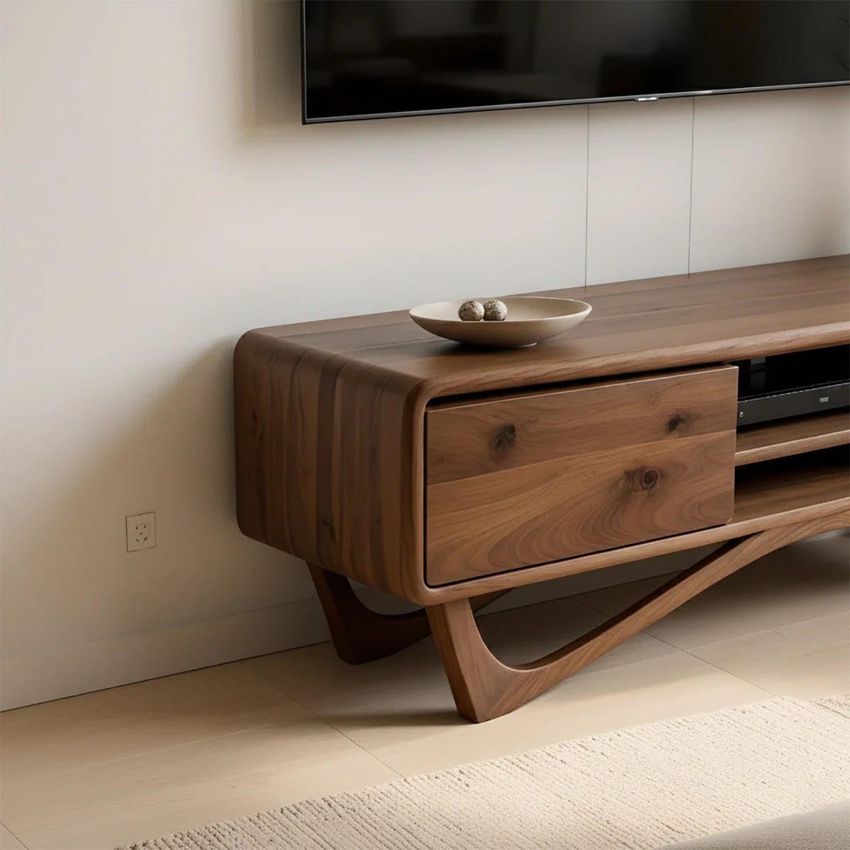 Designed with a walnut color finish, the TV stand highlights soft edges and balanced proportions