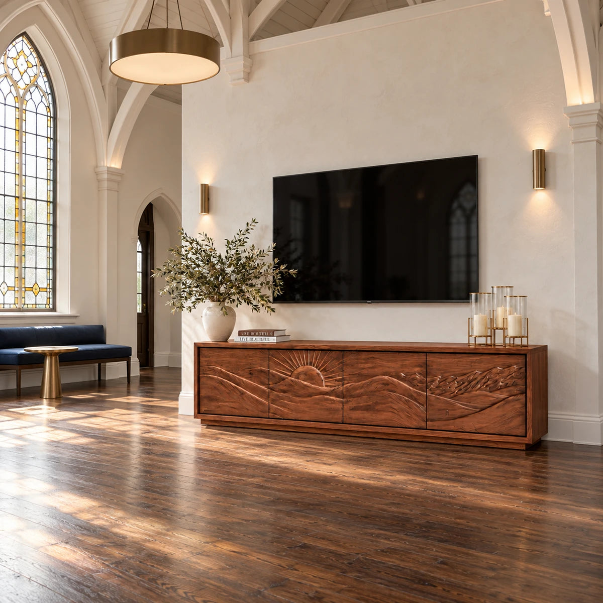 Designer entertainment unit in solid wood with carved nature motif and sleek base
