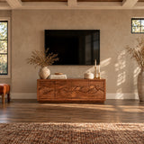 Wide entertainment console in solid wood with sculpted landscape front panels and storage

