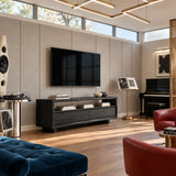 Low TV stand in natural solid wood with walnut tone finish and open shelf storage