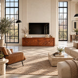 Modern media console in solid wood with scenic relief panels and broad concealed storage
